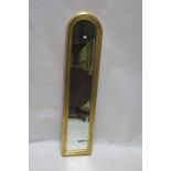 A GILT NARROW ARCH TOP WALL MIRROR