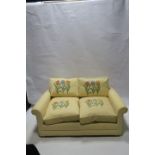 A MODERN TWO SEATER SOFA,