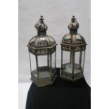 A PAIR OF COPPER AND GLAZED LANTERNS, each of rectangular outline with corona crestings, 63cms high.