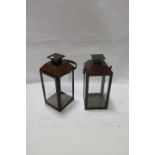 A PAIR OF BRASS AND LEATHER BOUND LANTERNS,