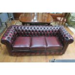 A WINE LEATHER UPHOLSTERED CHESTERFIELD STYLE SOFA,