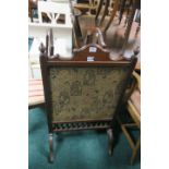 AN EDWARDIAN MAHOGANY FIRE SCREEN WITH UPHOLSTERED PANEL, on standard end supports, 97cms x 58cms.