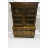 A VICTORIAN MAHOGANY BOOKCASE the moulded cornice above a plain frieze with a pair of glazed doors