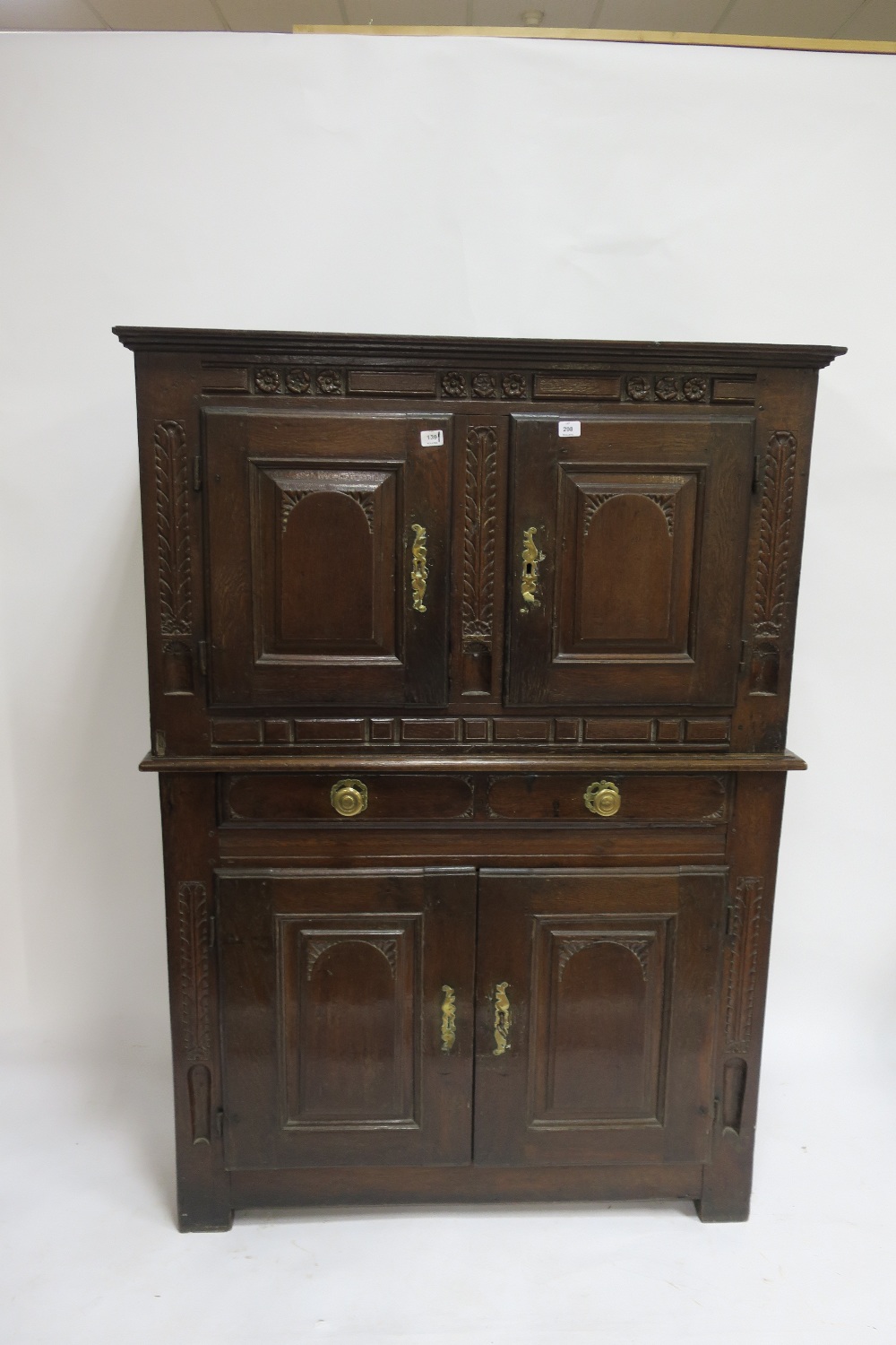 AN 18TH CENTURY OAK CARVED DRESSER the rectangular top with a pair of panelled doors above the