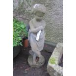 A COMPOSITION STONE FIGURE modelled as a young boy depicting winter 89cm high