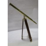 A BRASS TELESCOPE, on hardwood folding telescopic tripod, 163cms high.