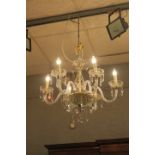 A CUT GLASS FIVE BRANCH CHANDELIER, with scroll arms hung with pendant drops.