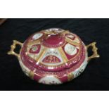 A CONTINENTAL STYLE TUREEN of circular bulbous outline the pink ground decorated with foliate and