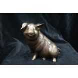 A BRONZE FIGURE, modelled as a Pig shown seated, 20cms high.