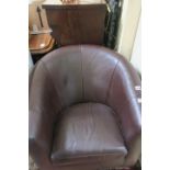 A BROWN HIDE UPHOLSTERED TUB SHAPED CHAIR, with loose cushion on moulded legs.