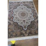 A RECTANGULAR WOOL RUG, the cream ground decorated overall with foliate filled panels,