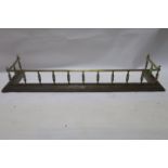 A GOOD BRASS FENDER, 19th CENTURY, the moulded top rail raised on turned supports with stepped base,