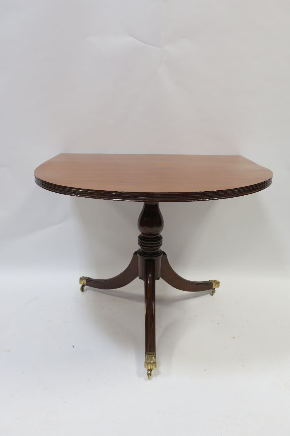 A GOOD REGENCY STYLE MAHOGANY AND SATINWOOD INLAID THREE POD D-END DINING ROOM TABLE the