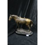 A BRONZE FIGURE MODELLED AS A HORSE, shown standing on a naturalistic base, 26cms high.