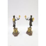 A PAIR OF EMPIRE STYLE GILT BRONZE CANDELABRA in the form of a classical female shown standing on a