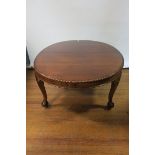 A GEORGIAN STYLE MAHOGANY OVAL TOP DINING ROOM TABLE the gadrooned rim above a recessed frieze