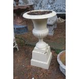 A VICTORIAN STYLE CAST IRON URN ON BASE