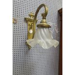 A PAIR OF REGENCY STYLE BRASS FRAMED WALL SCONCES the rectangluar back plate headed by a classical