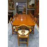 A REGENCY STYLE BURR WALNUT VENEERED DINING ROOM SUITE comprising of a rectangular top table with