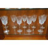 A SET OF TEN WATERFORD CUT GLASS RED WINE GLASSES with gilded rims on octagonal tapering stem with