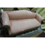 AN EARLY 20TH CENTURY MAHOGANY FRAMED HUMPBACKED SOFA in peach silk striped upholstery with