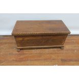 A RECTANGULAR FOLIATE CARVED CHEST typical form with hinged lid 58cm X 105cm X 48cm