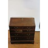 A GEORGIAN MAHOGANY CROSSBANDED BUREAU,