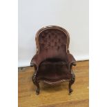 A VICTORIAN MAHOGANY ARMCHAIR the moulded frame above a buttoned upholstered back scrolled arms,