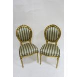 A PAIR OF GILT FRAMED CONTINENTAL STYLE DINING ROOM CHAIRS the circular moulded frames headed by a