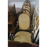 A SET OF FOUR BENTWOOD ELBOW CHAIRS, with caned back and seat on moulded legs.