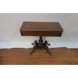 A REGENCY ROSEWOOD AND BRASS INLAID FOLD OVER TOP GAMES TABLE the rectangular top with rounded