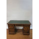 A 20TH CENTURY KNEEHOLE DESK the rectangular green leathered tooled top above a central frieze