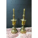 A PAIR OF BRASS FRAMED TABLE LAMPS in the form of circular urns headed by a pineapple finial on