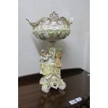 A CONTINENTAL STYLE GLAZED AND PAINTED PORCELAIN CENTRE PIECE,