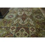 AN ISRAELI WOOL RUG, the gold and cream ground with overall floral pattern, 360cms x 253cms.