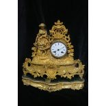 A FRENCH GILT METAL MANTEL CLOCK, the enamelled dial with Roman numerals,