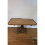 A 19TH CENTURY MAHOGANY BREAKFAST TABLE the rectangular top with rosewood border and rounded