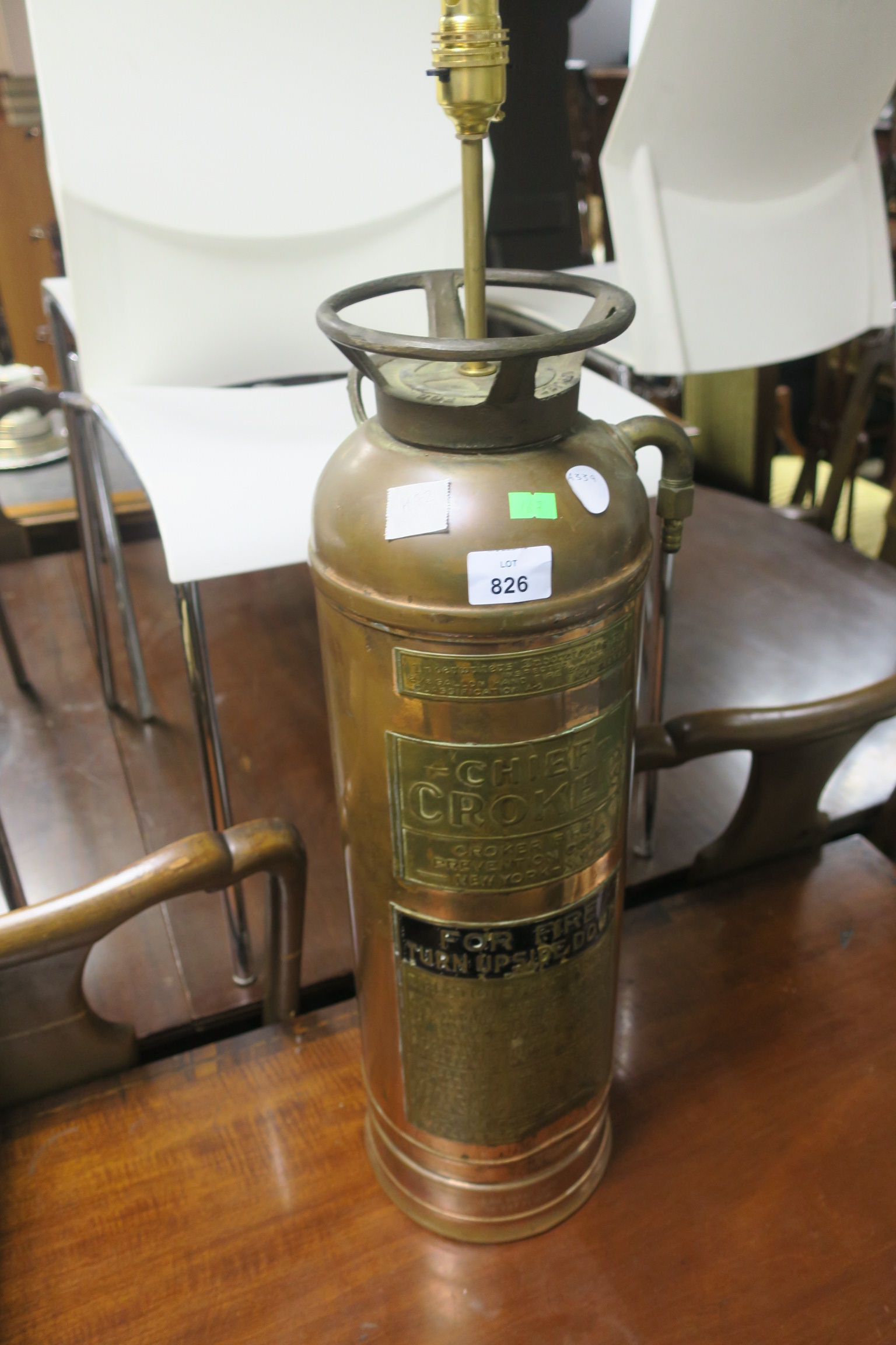 A BRASS AND COPPER FIRE EXTINGUISHER, in the form of a table lamp, enscribed Chief Croker New York.