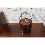 A LEATHER FRAMED ICE BUCKET OF CIRCULAR FORM the lid with brass mounts and carrying handle above