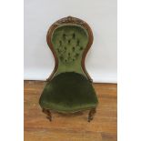 A VICTORIAN MAHOGANY CARVED LADIES ARMCHAIR the waisted back headed by a foliate cartouche with