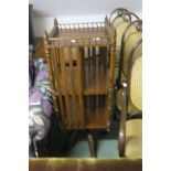 A MAHOGANY REVOLVING BOOKSTAND with slatted uprights on reeded legs 120cm 42cm