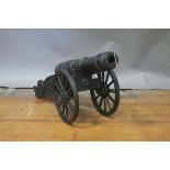 A CAST IRON CANNON, of typical form, 46cms x 94cms.