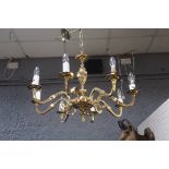 A CONTINENTAL STYLE BRASS FRAMED EIGHT BRANCH CENTRE LIGHT,