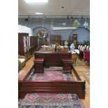 A MAHOGANY FRAMED SLEIGH BED of typical form with rounded panelled ends joined by rectangular plank