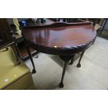 A PAIR OF CHIPPENDALE STYLE MAHOGANY SIDE TABLES each of demilune outline on cabriole legs with pad