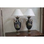 A PAIR OF EMPIRE STYLE TABLE LAMPS in the form of classical urns the black ground decorated with