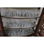 A LARGE COLLECTION OF CUT GLASS including champagne flutes, brandy balloons, wine glasses,