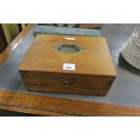 A PINE WRITING CASE, the rectangular hinged lid with brass handle with fitted interior,