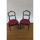 A PAIR OF BLACK AND GILT BRASS MOUNTED CONTINENTAL STYLE SINGLE CHAIRS,