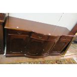 A GEORGIAN STYLE MAHOGANY SIDE CABINET, of rectangular bowed outline,